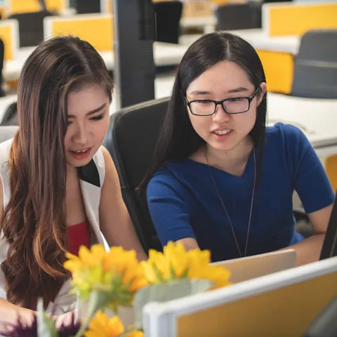 Two students working on a computer.