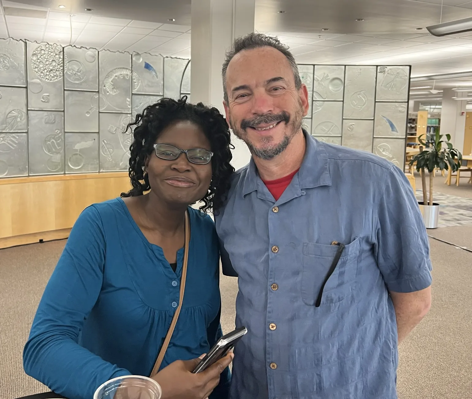 Two teachers standing in the Kraemer Family Library Center 