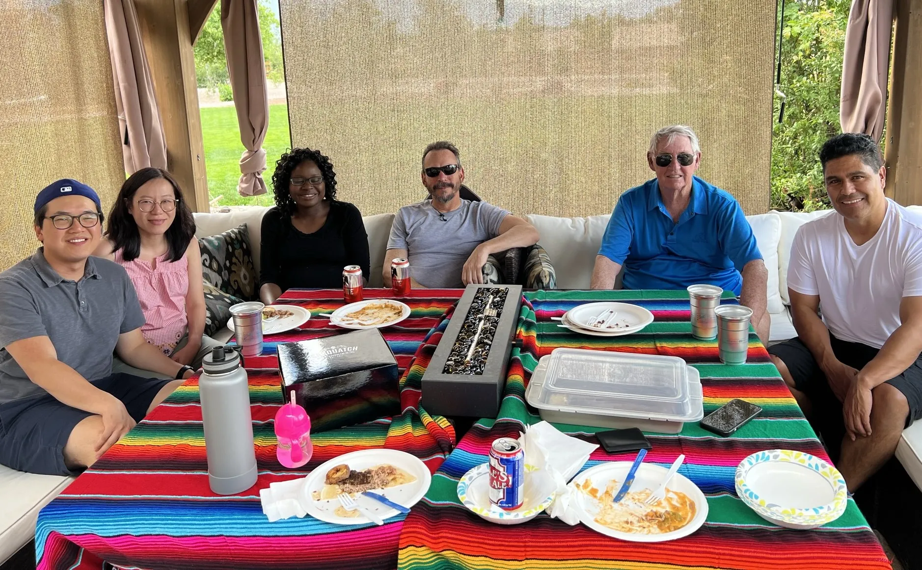 Group of teachers and faculty around a colourful table. 